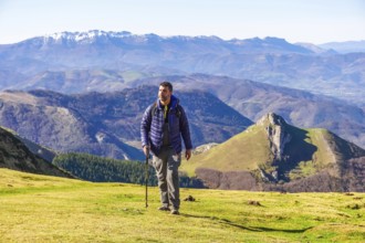 Male hiker enjoying a sunny day trekking in the mountains of the basque country, spain, with