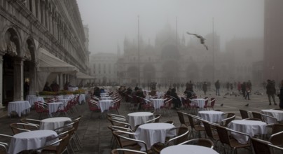 Italy Venice St Mark's Square -46 Café Lavena outdoor seating on a foggy November day behind St