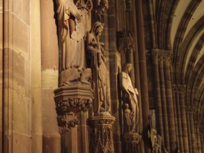 Close-up of gothic statues in the interior of a cathedral with rich architecture, strasbourg,