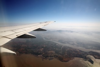 Wing of aircraft flying in sky