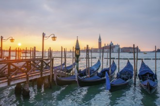 Cloudy atmosphere at sunrise, gondolas, San Giorgio Maggiore church in the background, Venice,