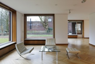 Interior (living room with retractable windows) of Haus Lange with a view of the garden to the east