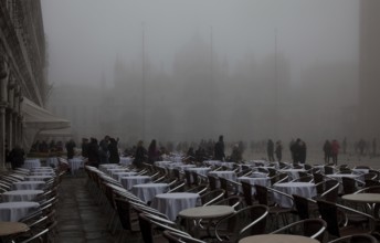 Italy Venice St Mark's Square -50 Café Lavena outdoor seating on a foggy November day behind St