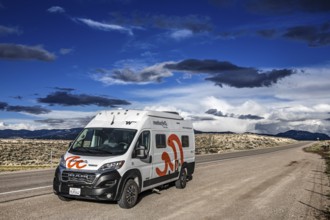 Motorhomes in the midst of wild thunderstorms and rain clouds, on the Great Basin Highway US 93,