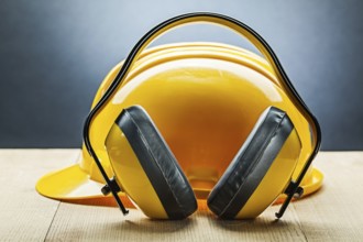 Earphones with yellow construction helmet