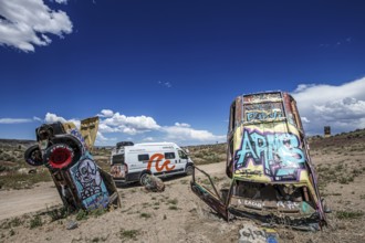 Motorhome and scrap cars decorated with graffiti in the Carforest of Goldfield, Nevada, USA, North