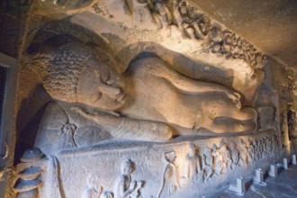 Huge figure of reclining buddha laying back in preparation for nirvana at ajanta caves, Aurangabad,