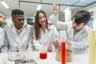 University students in lab coats conducting a chemistry experiment, using lab equipment and