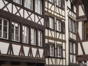 Half-timbered houses with detailed woodwork and numerous windows in an urban setting, strasbourg,