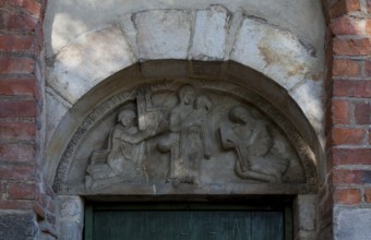 Foundation tympanum, St Anne carrying Mary, on the left son Krystyn of the founder Piotr