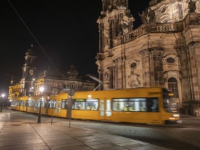 Yellow tram passes illuminated historical buildings at night, Dresden, Saxony, Germany, Europe