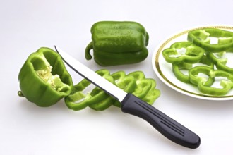 Knife with slices of Green Capsicums Latin Capsicum Annuum on a plate, salad, India, Asia