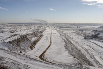 Landscape in the snow, power station in the background