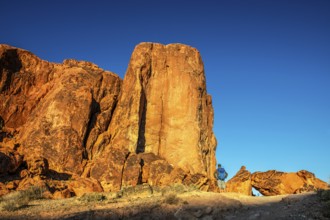 Hiker in front of Gibraltar Rock, Valley of Fire State Park, Nevada, USA, North America