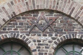 Door of the former blacksmith's workshop, wall relief with compass and drawing triangle, possibly a