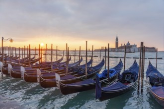 Cloudy atmosphere at sunrise, gondolas, San Giorgio Maggiore church in the background, Venice,