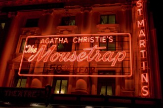 Agatha Christie Mousetrap at St Martins buildings illuminated red neon signboard, London, UK United