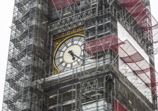 London, Big Ben clock face in the centre of the scaffolding