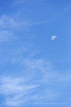 Light clouds in blue sky, waning moon, blurred, full-frame, East Sussex, South Downs, England,