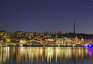 City at night with illuminated buildings and reflections in the water, Capital, Södermalm,