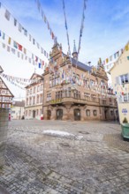 Historic building with colourful pennants on a square surrounded by half-timbered houses, Meßkirch,