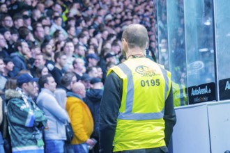 Security guard monitors the action in the stadium during a sporting event, Heilbronner Falken Vs