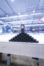 Pyramid-shaped stacked ice hockey pucks in a large ice rink, Heilbronner Falken Vs Bietigheimer