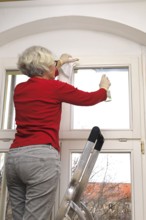 Cleaning flat windows, Germany, Europe