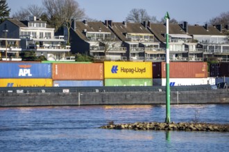 Container cargo ship on the Rhine near Düsseldorf-Bockum, villas on the banks of the Rhine, the