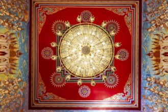 Frog's-eye view: Ceiling with chandelier of an art gallery with an exhibition of non-traditional