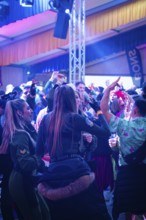 Dancing people enjoying a party with colourful lights in a tent, carnival, Schlagerkuchen Donzdorf,