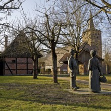 Artwork Farming family by Werner Klenk with St Nicholas Church in Wadersloh-Diestedde, Münsterland,