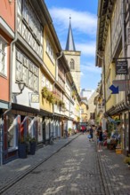 Everyday scene on the Krämerbrücke with a view of the Ägidienkirche in the historic old town of