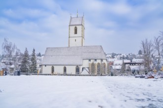 Large church stands in the snow against a blue sky, Aidlingen, Böblingen district, Germany, Europe