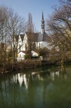 The Church of the Brethren is reflected in the River Lippe in spring in Lippstadt, North