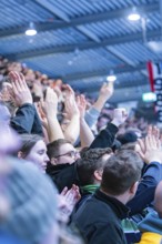 Cheering spectators in the stadium clap and raise their hands, Heilbronner Falken Vs Bietigheimer