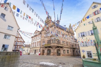 Historic building with colourful pennants and half-timbered houses on a cobbled square, Meßkirch,