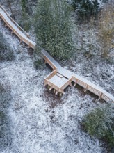 Wooden path with small platform in the snow-covered forest, New wooden walkway in the Calw city