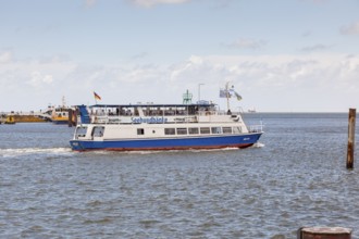 Small ship with tourists on a harbour tour in the port of Cuxhaven, Lower Saxony, Germany, Europe