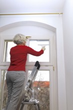 Cleaning flat windows, Germany, Europe