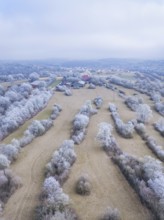 Winter aerial view of fields and a village with snow-covered hills, Gechingen, district of Calw,