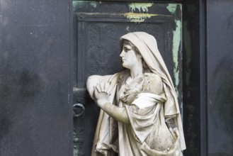 Figure of a praying woman at a historic grave, cemetery of the Emmaus Church in Kaditz, Dresden,