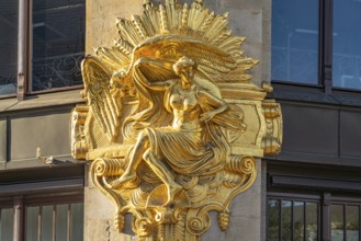 Gilded façade element with the allegory of hedonism on the former Art Nouveau department stores'