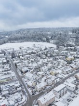 Winter scene of a village with snow-covered houses and streets, Aidlingen, Böblingen district,