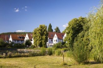 Village view of Naundorf, historic buildings with farmhouses, village green with pond, Radebeul,