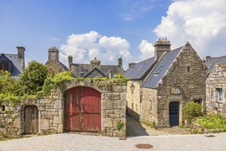 Idyllic old preserved French village with stone houses and wooden doors a sunny summer day,