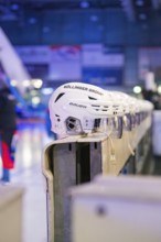 White ice hockey helmets are lined up in a sports hall, Heilbronner Falken Vs Bietigheimer