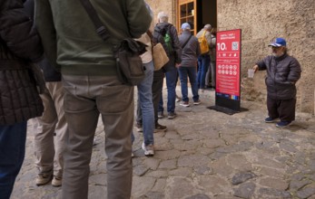 Queue, beggar, small, begging at the entrance of La Seu, Basilica de Santa Maria, Cathedral of St