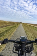 The East Frisian North Sea island of Juist in winter, cycling in the west of the island, on dyke