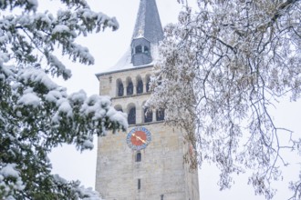 Church tower surrounded by snow-covered fir trees in winter, Aidlingen, Böblingen district,